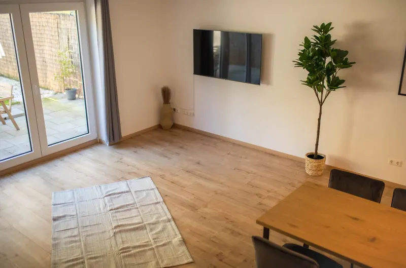 Wohnzimmer mit Teppich und Blick auf die Terrasse